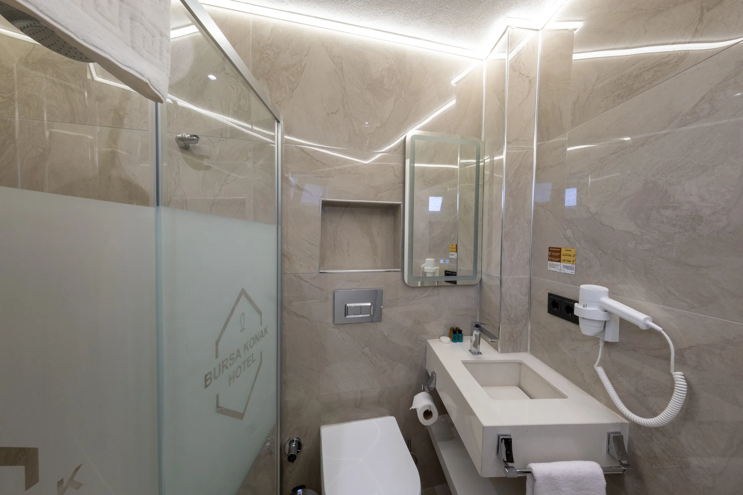 Quadruple oda banyosunda duşakabin ve lavabo